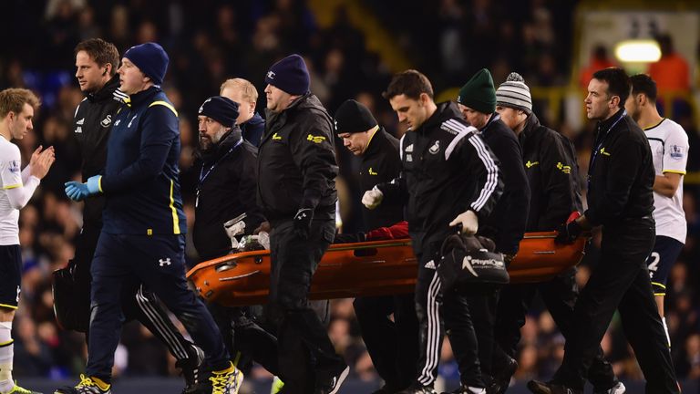 Bafetimbi Gomis of Swansea City is stretchered off at White Hart Lane