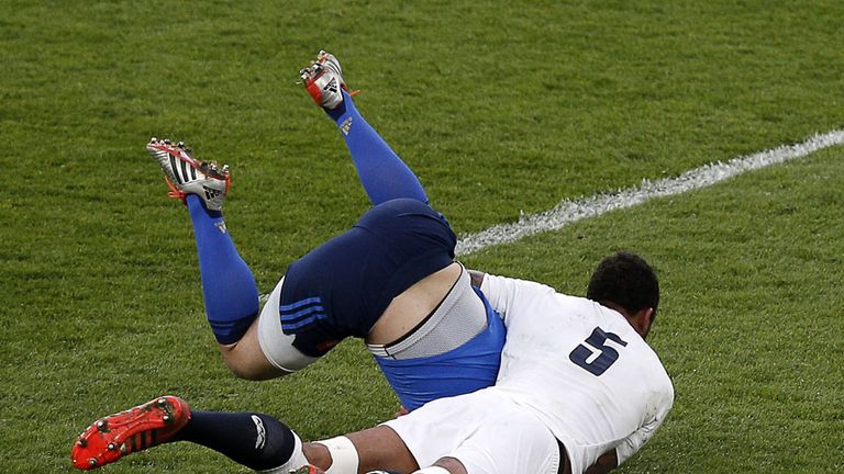 England lock Courtney Lawes tackles France's fly half Jules Plisson