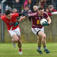 Westmeath centre-back Kieran Martin is tackled by Derek Maguire