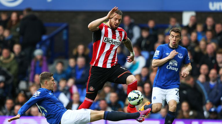 Everton's John Stones tackling Sunderland forward Connor Wickham