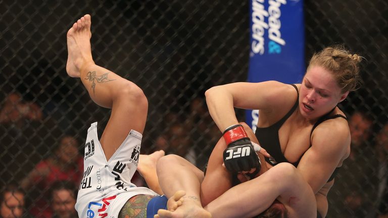 Rousey (top) and Carmouche were the first women to fight in the UFC Octagon