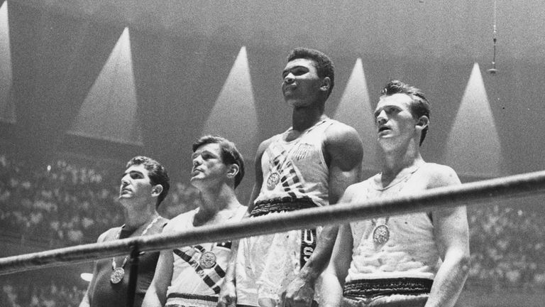 Muhammad Ali - then known as Cassius Clay - on top of the podium