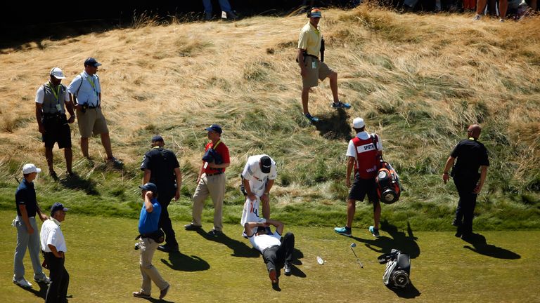 Jason Day lays on the ninth hole