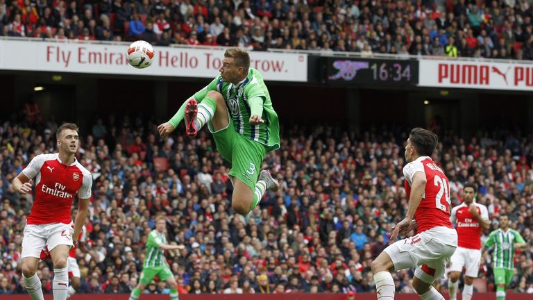 Wolfsburg striker Nicklas Bendtner jumps to control the ball inside the area