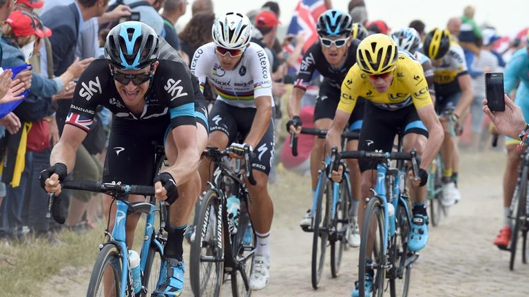 Ian Stannard ushers Chris Froome over one of the cobbled sectors