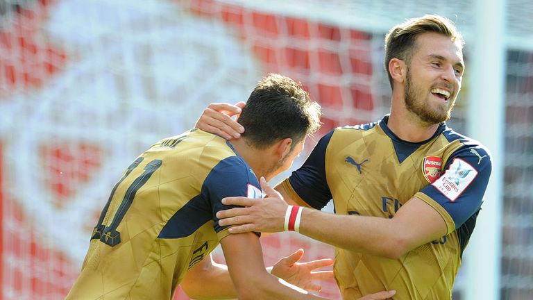 Mesut Ozil celebrates scoring Arsenal's fifth goal with Aaron Ramsey