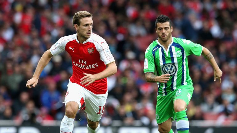 Nacho Monreal of Arsenal is tracked by Wolfsburg's Vieirinha