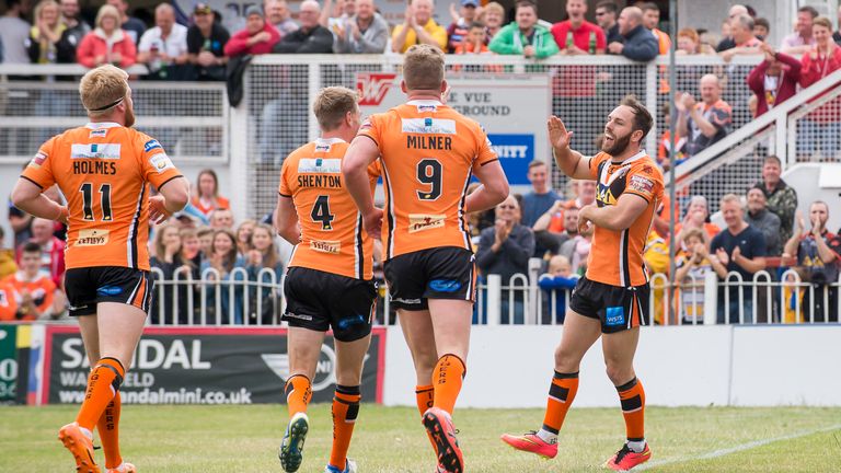 Luke Gale (right) is congratulated by his team-mates after scoring a try