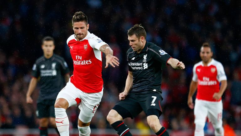 Olivier Giroud and James Milner battle for the ball