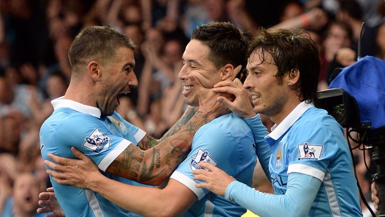 Samir Nasri celebrates with Aleksandar Kolarov and David Silva during City's 2-0 win at Everton