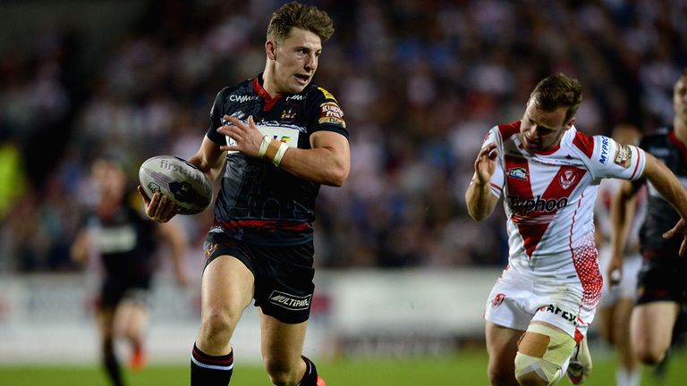 George Williams of Wigan Warriors runs past Adam Quinlan of St Helens