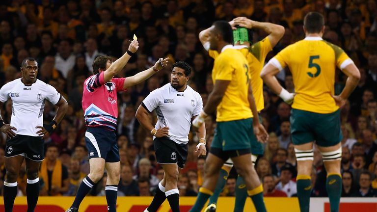 Referee John Lacey  shows Campese Ma'afu of Fiji a yellow card