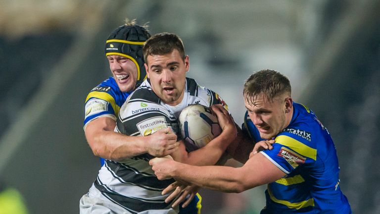 Hull FC's Josh Bowden is tackled by Warrington's Chris Hill and Ben Currie