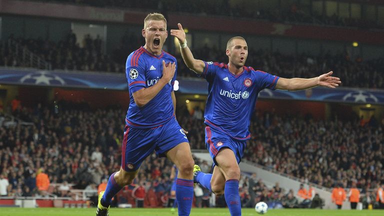 Olympiakos's Alfreo Finnbogason celebrates scoring their third goal with Pajtim Kasami