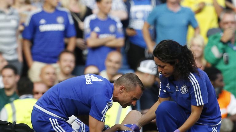 Carneiro and head physio Jon Fearn treat Eden Hazard at Stamford Bridge in August 2015