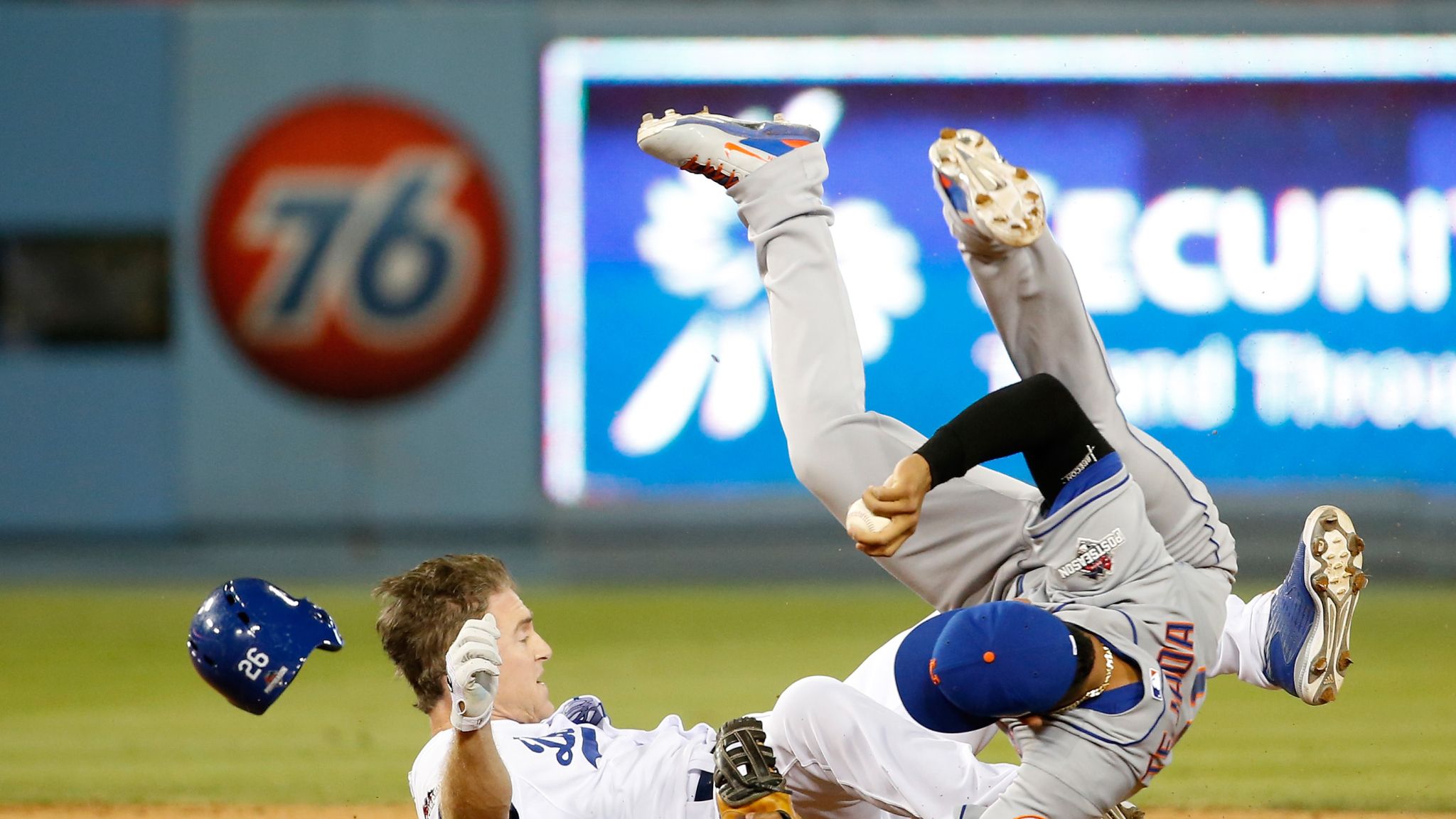 New York Mets' David Wright, center, slides into third base after