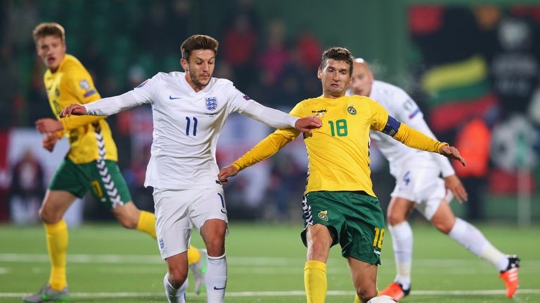 Adam Lallana competes for possession against Lithuania