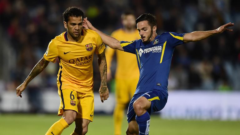 Barcelona defender Dani Alves (left) vies with Getafe midfielder Victor Rodriguez
