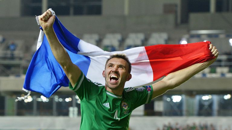 Gareth McAuley celebrates Northern Ireland clinching qualification to Euro 2016