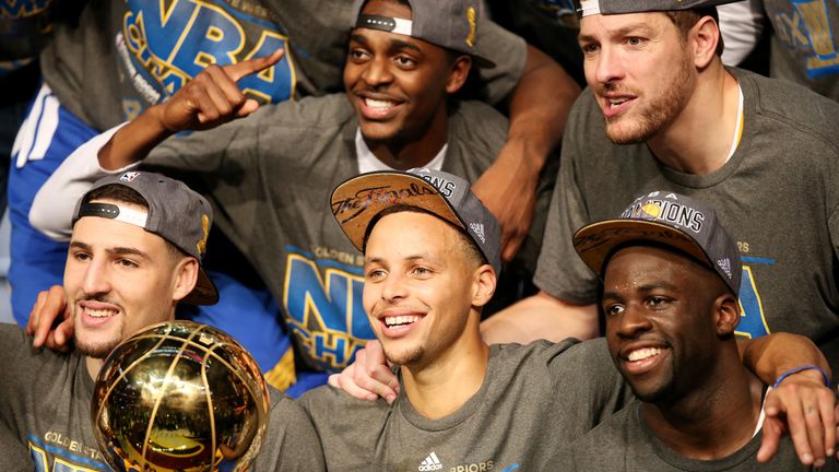 Klay Thompson (left), Stephen Curry (centre) and Draymond Green (right) of the Golden State Warriors celebrate with the Larry O'Brien NBA Championship Trophy