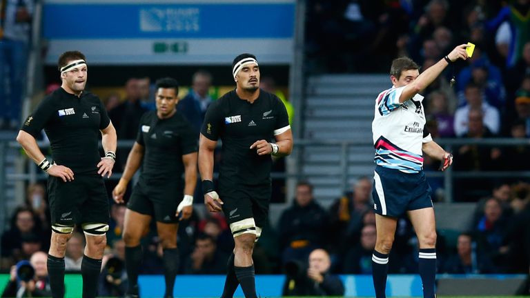 Try-scorer Jerome Kaino is yellow carded by referee Jerome Garces