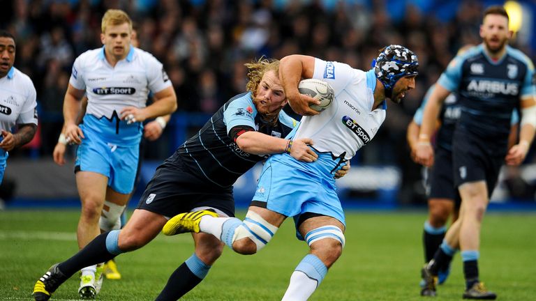 Glasgow's Josh Strauss is tackled by Kristian Dacey of Cardiff