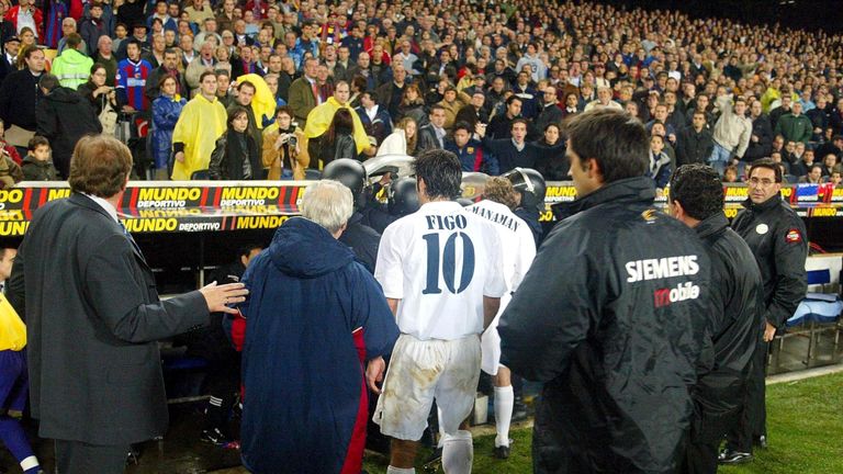 Figo leaves the pitch as play was suspended during the La Liga match between Barcelona and Real Madrid