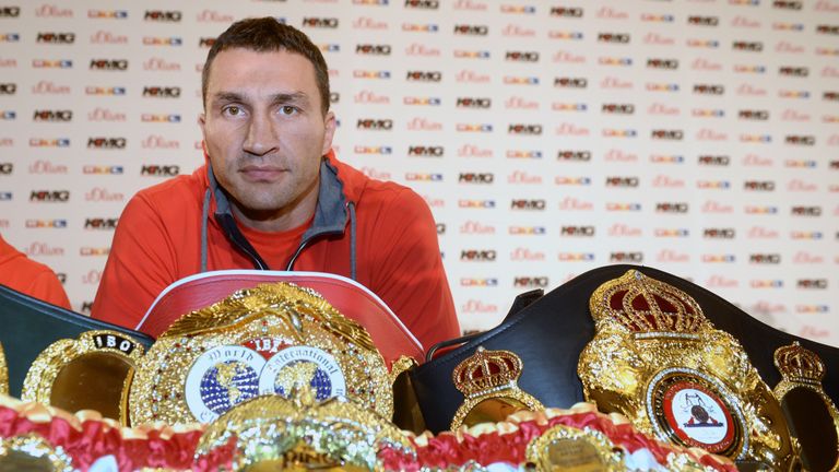 Wladimir Klitschko poses with his heavyweight title belts