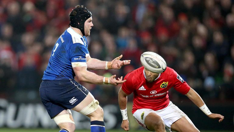 Leinster's Sean O'Brien passes before being tackled by Munster's Simon Zebo