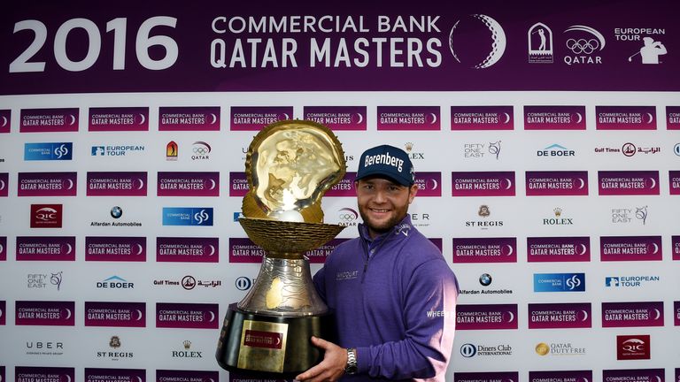 Grace lifts the Qatar Masters trophy for the second year running