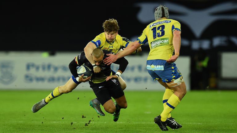Ospreys wing Eli Walker is tackled by David Strettle and Jonathan Davies (right) of Clermont