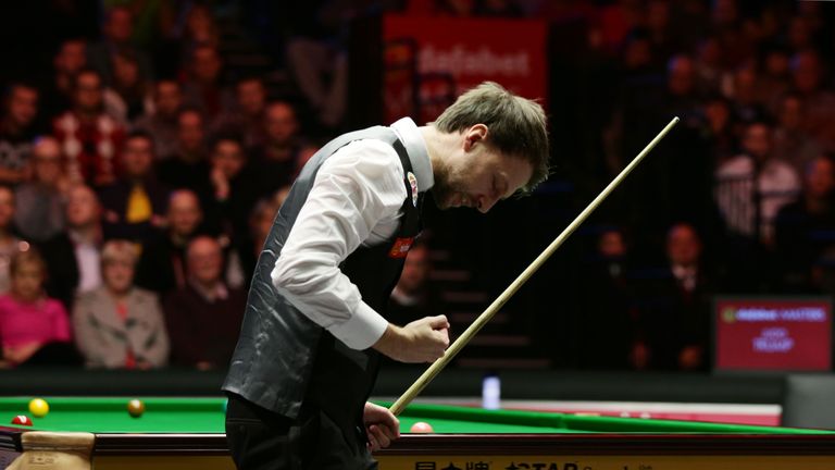 Judd Trump celebrates towards the end of a thrilling match