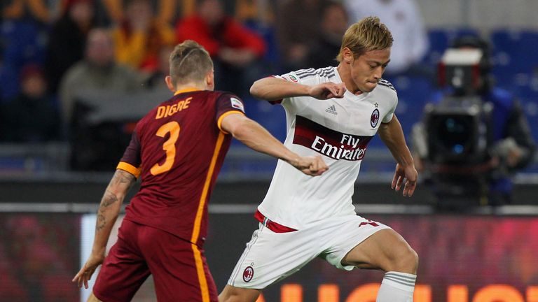 Keisuke Honda competes for the ball with Lucas Digne