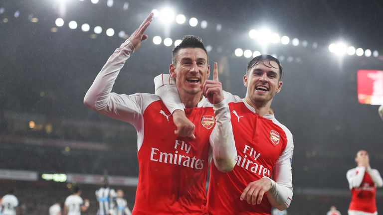Laurent Koscielny (left) celebrates netting the winner against Newcastle