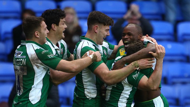 Topsy Ojo of London Irish (R) celebrates with team mates