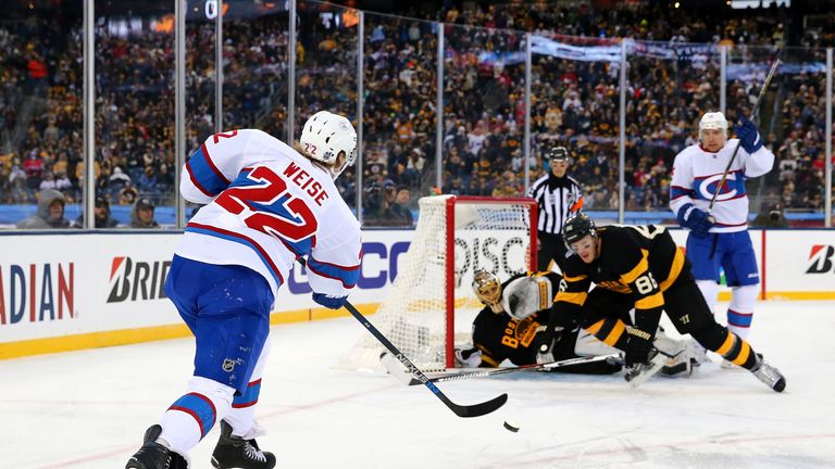 Dale Weise shoots as goaltender Tuukka Rask and Kevan Miller look to block the puck