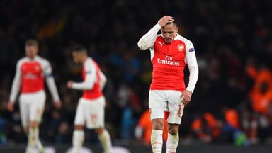 A dejected Alexis Sanchez reacts to Barcelona's win at the Emirates