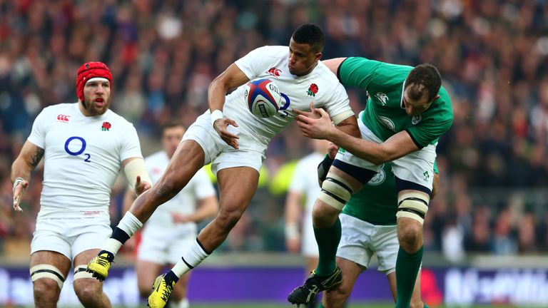 Try scorer Anthony Watson of England and Devin Toner of Ireland compete for a high ball