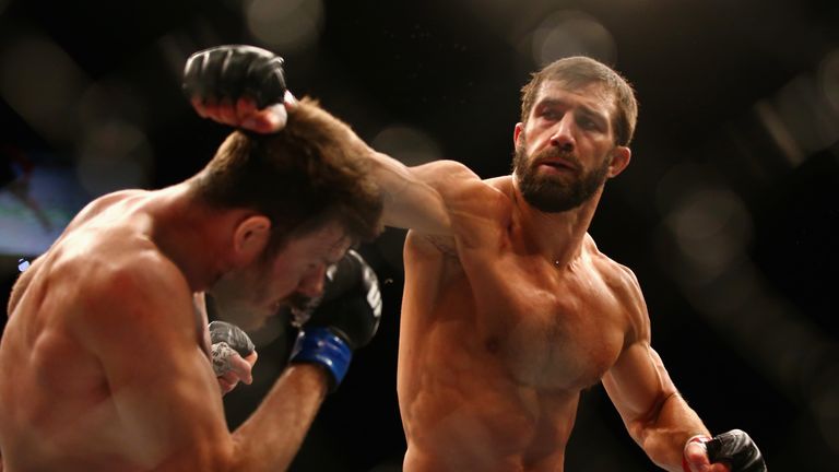 Luke Rockhold (right) fires a punch at Michael Bisping en route to a stoppage win
