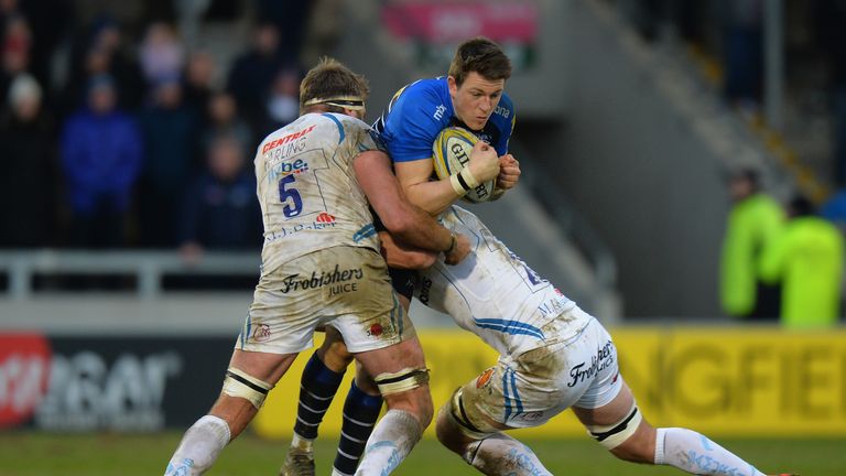 Sam James is tackled by Exeter duo Geoff Parling and Kai Horstmann