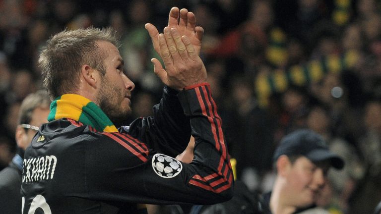 David Beckham wears a green and gold scarf after Champions League tie at Old Trafford