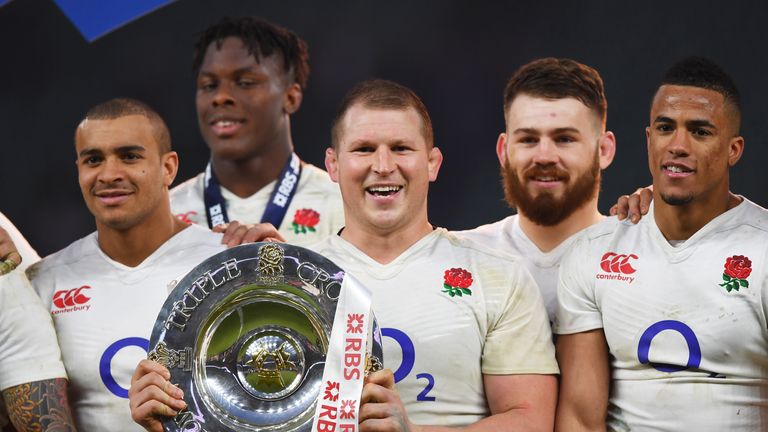 England captain Dylan Hartley lifts the Triple Crown trophy at Twickenham