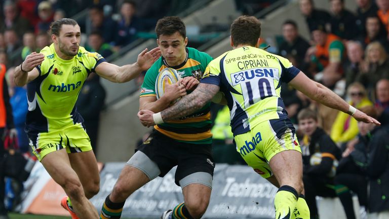 Tom Collins of Northampton Saints runs into the Sale Sharks defence