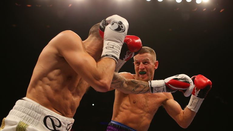 Terry Flanagan (R) fends off a Derry Mathews attack during his points win in Liverpool