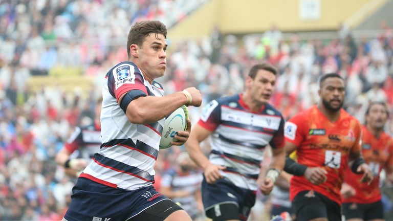 Tom English (left) races clear to score the third Rebels try