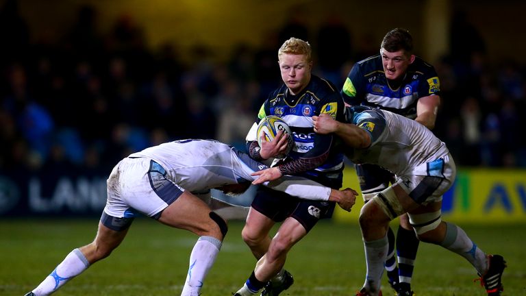  Tom Homer of Bath is tackled by Calum Green and Chris Harris of Newcastle 