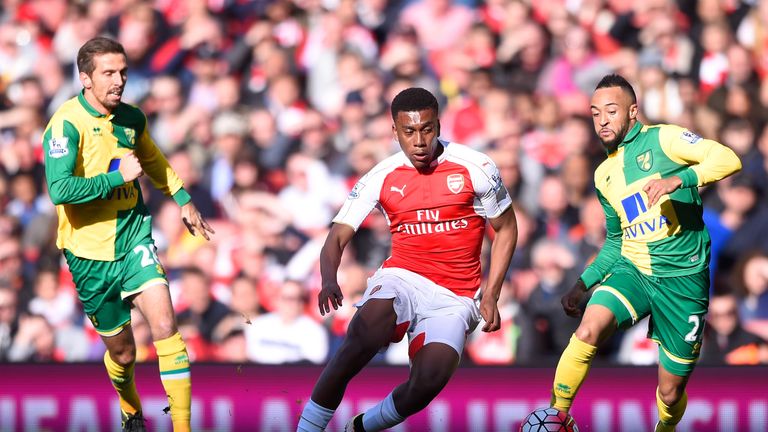 Alex Iwobi (C) of Arsenal competes for the ball against Gary O'Neil (L) and Nathan Redmond (R) of Norwich City, Premier League