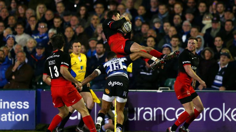 Alex Goode of Saracens is tackled in the air by Anthony Watson, resulting in a red card for the Bath full-back