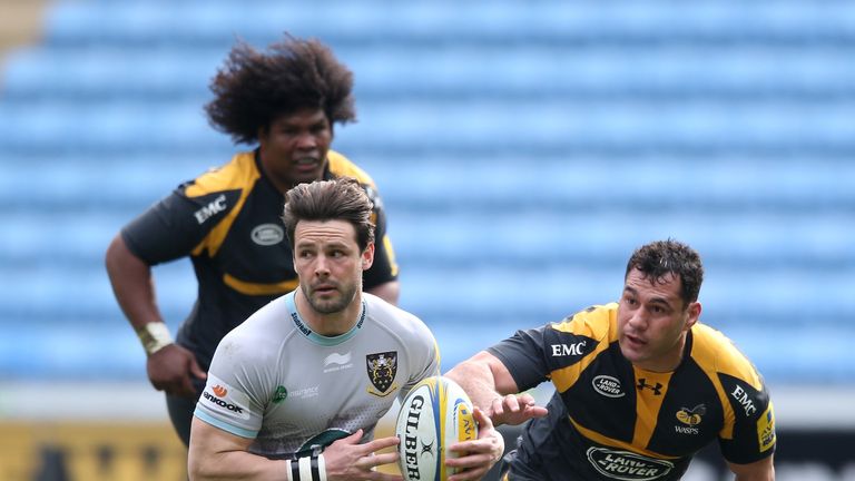 Ben Foden of Northampton turns with the ball watched by George Smith (R) and Ashley Johnson of Wasps