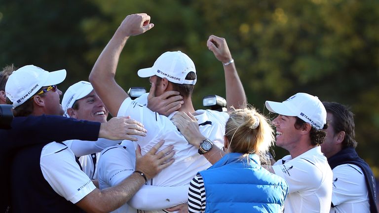 Martin Kaymer of Europe is congratulated after making the putt that retained the Ryder Cup in Medinah